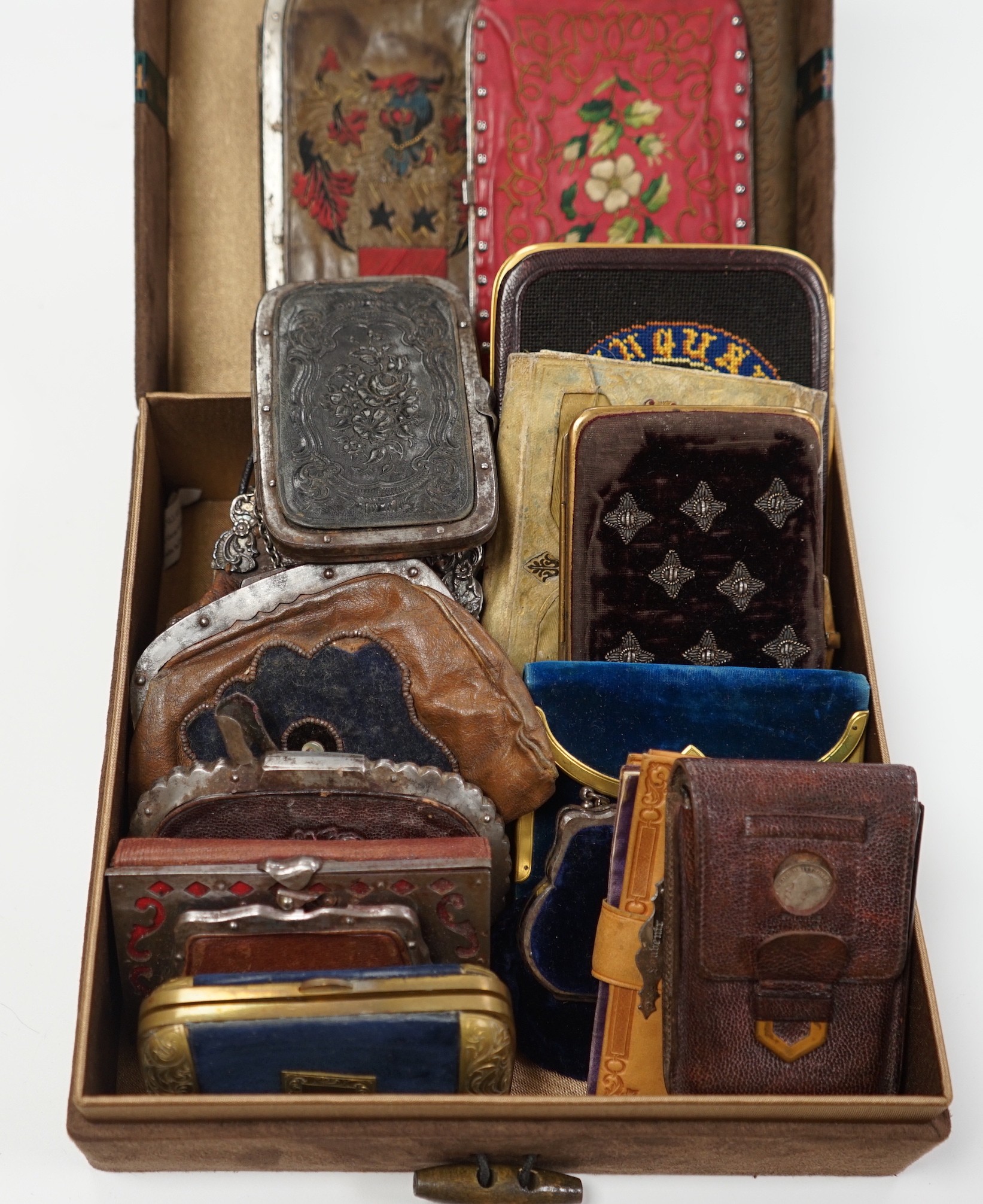 A collection of early 19th century and later embroidered, petite point, leather cut steel and velvet purses card cases etc